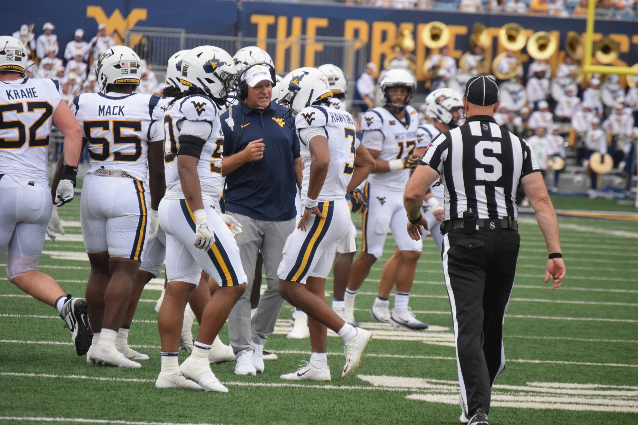 WVU Football HC Rich Rodriguez in huddle with players and Michael Hawkins