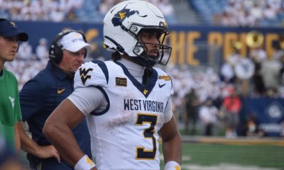 WVU Football QB Michael Hawkins with Rich Rodriguez behind him