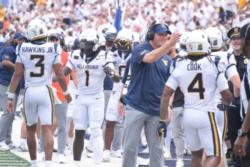 WVU Football sideline after Cam Cook touchdown celebration stock photo
