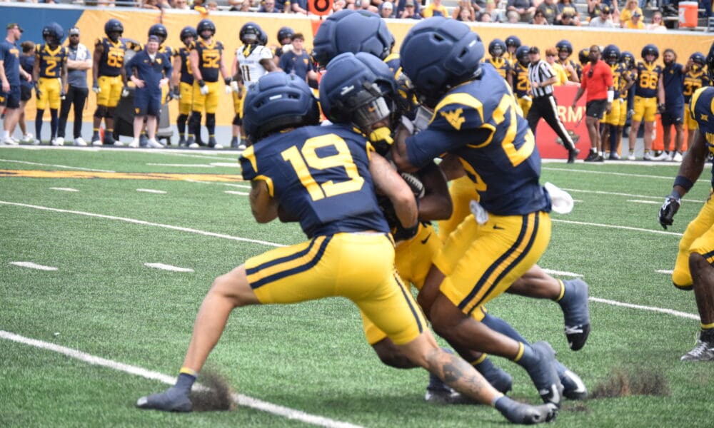 WVU Football CB Nick Taylor and others make a tackle during scrimmage