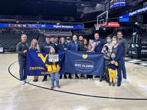 Taylor Scarnato with WVU fans on court 