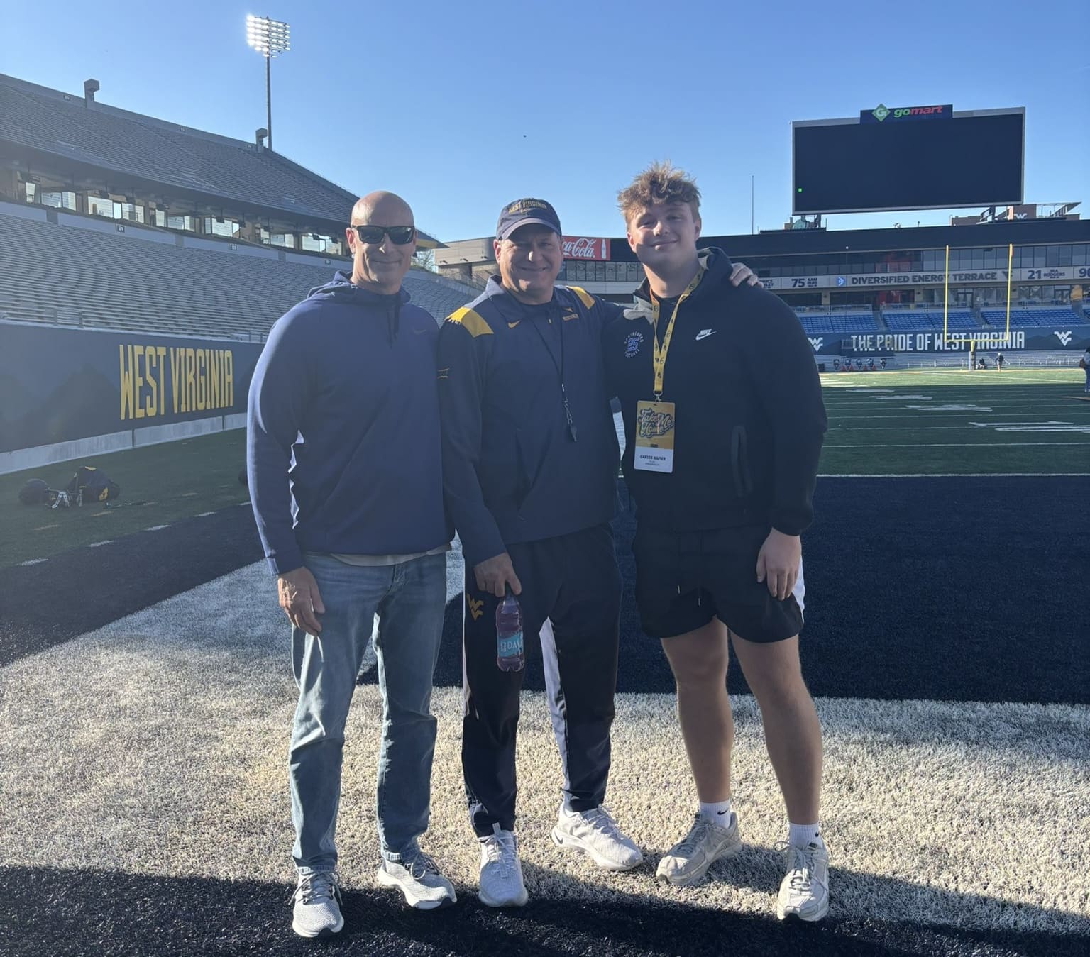 WVU Football DL recruit Carter Napier with Rich Rodriguez on field