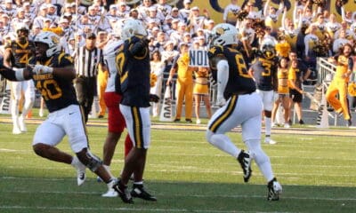 WVU Defense Celebration Josiah Trotter, Anthony Wilson, and Tyrin Bradley