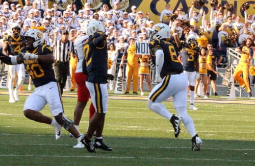 WVU Defense Celebration Josiah Trotter, Anthony Wilson, and Tyrin Bradley