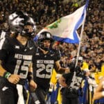 WVU Football WR Preston Fox with flag before Coal Rush game