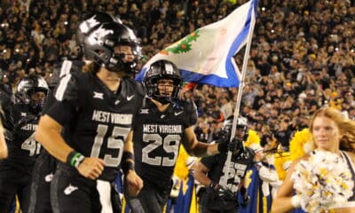 WVU Football WR Preston with flag before Coal Rush game