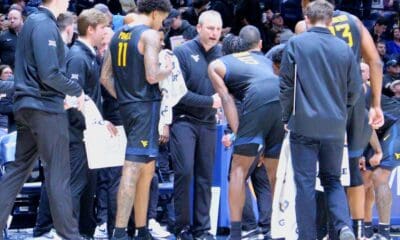 WVU Basketball HC Darian DeVries in WVU basketball huddle