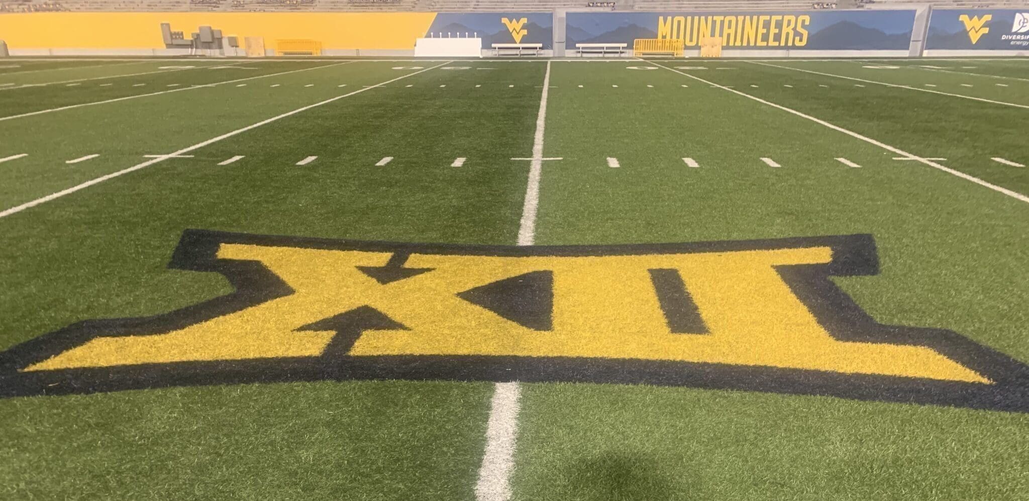 Big 12 logo on WVU football field stock