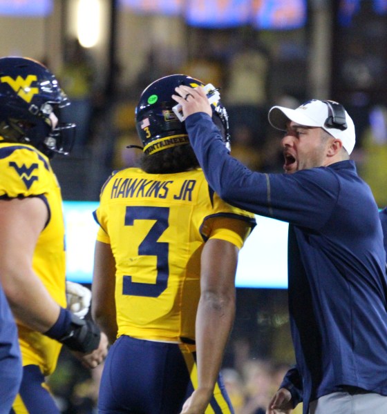 WVU Football HC Rich Rodriguez congratulates Michael Hawkins