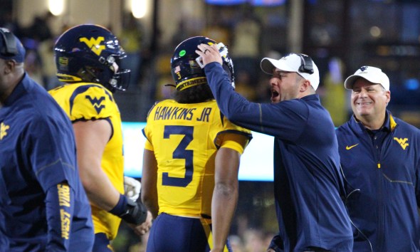 WVU Football HC Rich Rodriguez congratulates Michael Hawkins