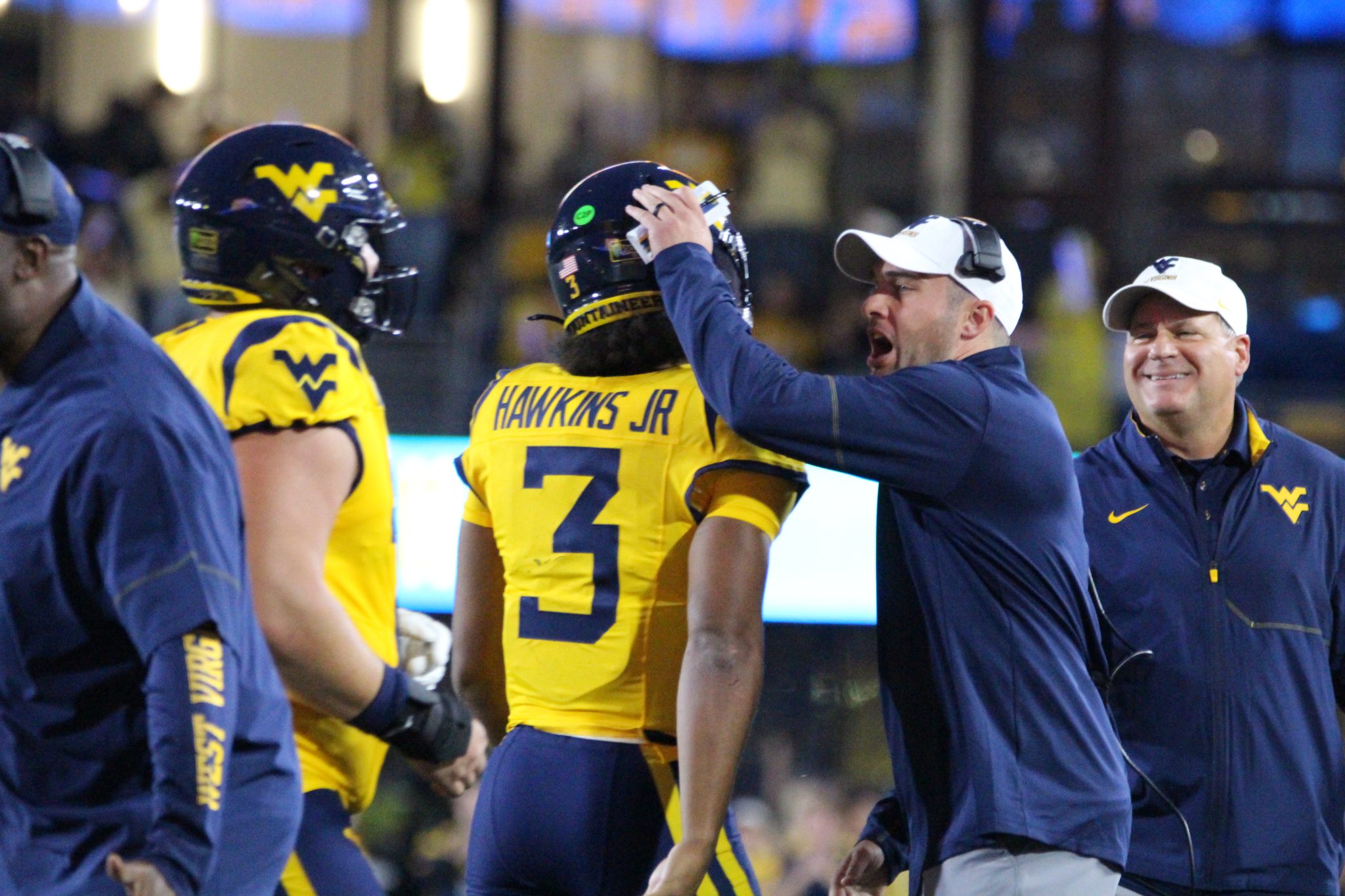 WVU Football HC Rich Rodriguez congratulates Michael Hawkins
