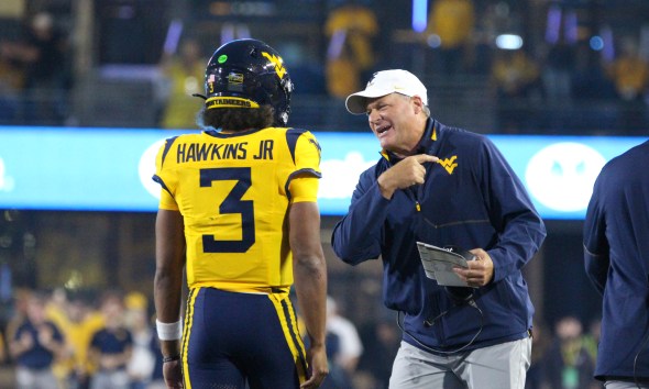 WVU Football HC Rich Rodriguez congratulates Michael Hawkins