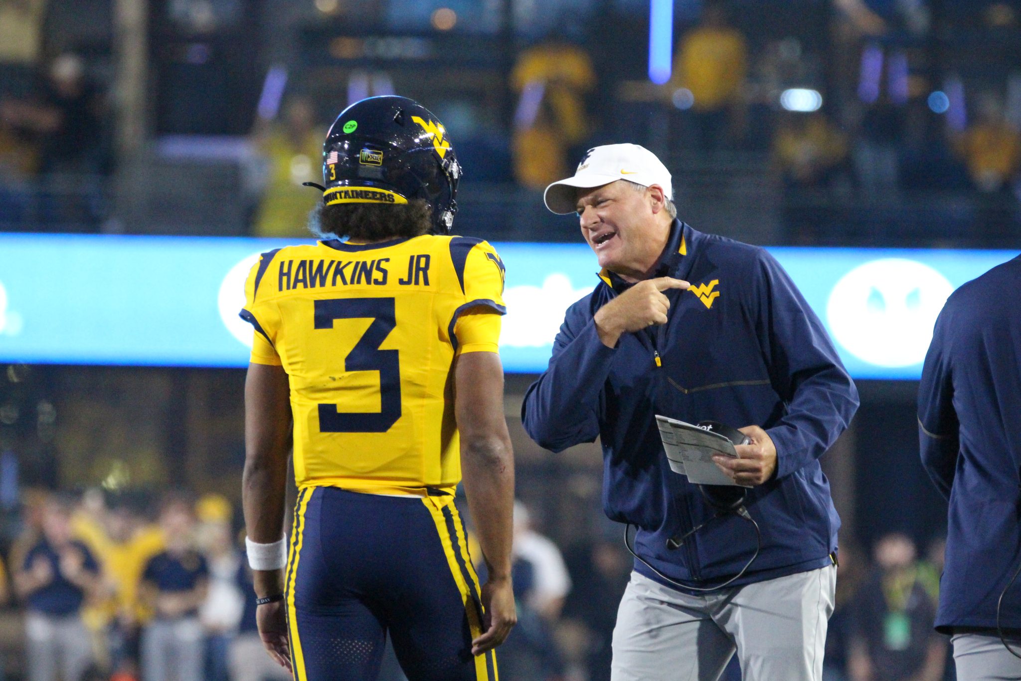 WVU Football HC Rich Rodriguez congratulates Michael Hawkins