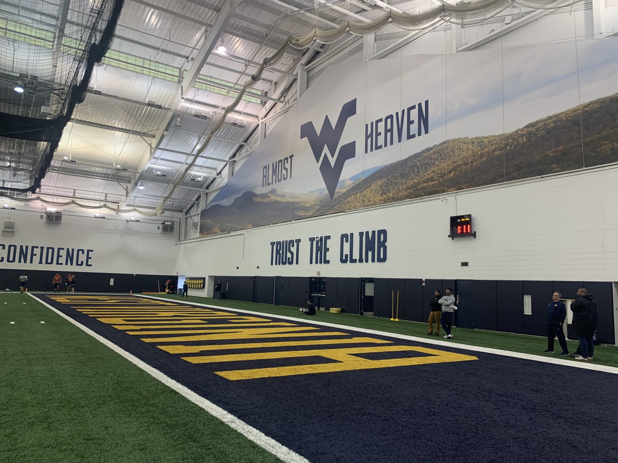 WVU Football indoor facility with Trust The Climb stock