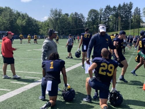 WVU Football OC Chad Scott and WR coach Bilal Marshall talking to Jahiem White and Preston Fox