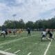 WVU Football WR Coach Bilal Marshall runs a drill during fall camp practice