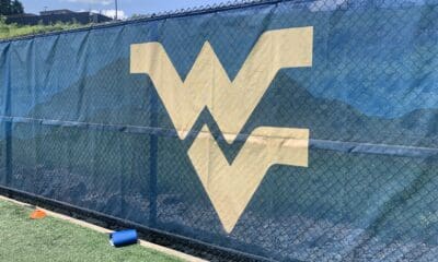 WVU Football stock logo on practice field wall