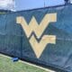 WVU Football stock logo on practice field wall
