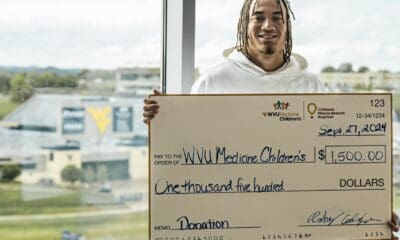 Rodney Gallagher with check at hospital