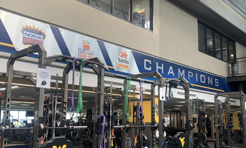 WVU Football major bowl wins on wall of weight room stock
