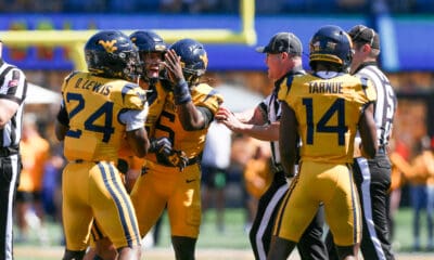 WVU Football defense celebrates against RMU with Darrian Lewis