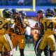 WVU Football defense celebrates against RMU with Darrian Lewis