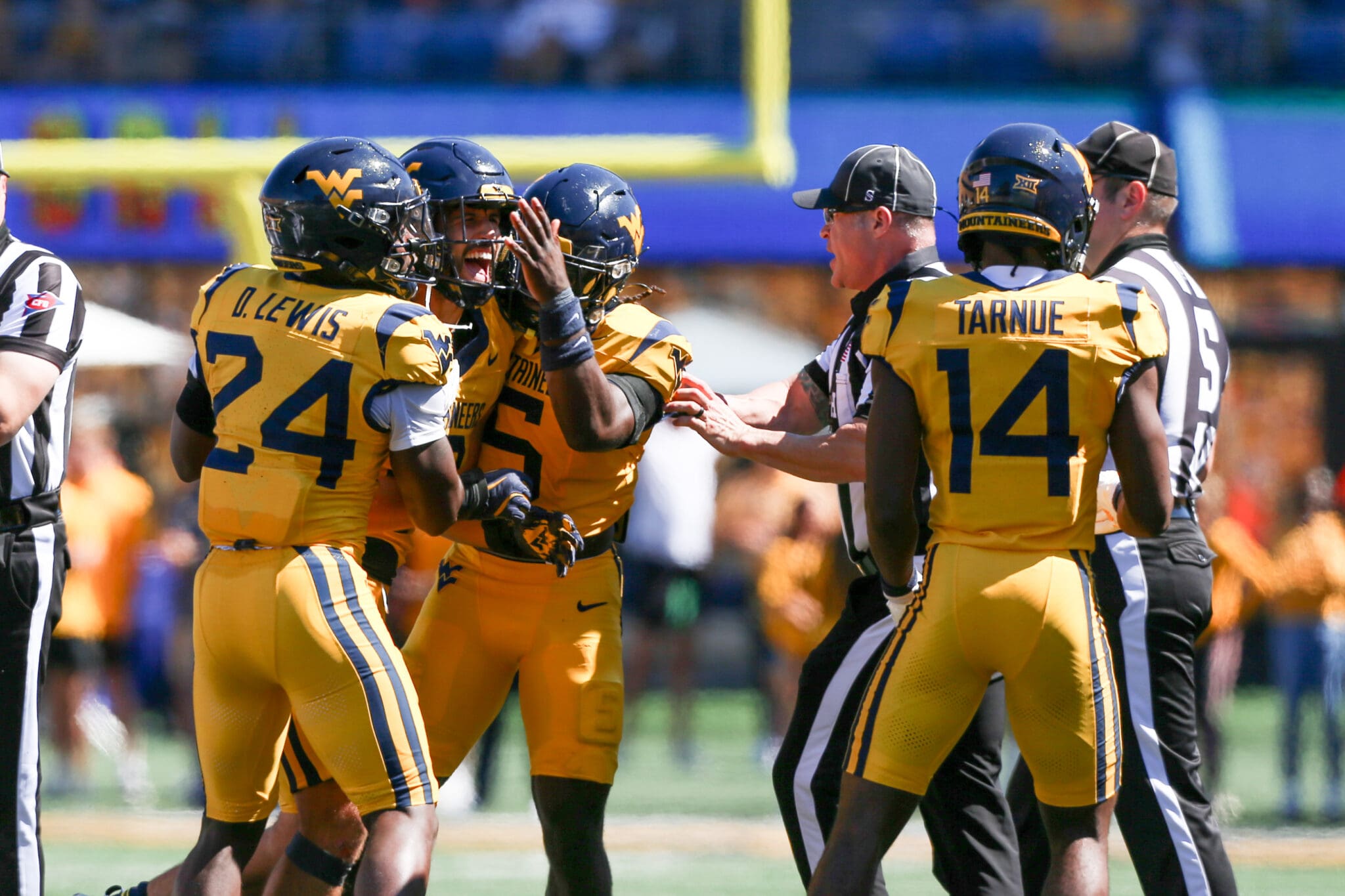 WVU Football defense celebrates against RMU with Darrian Lewis