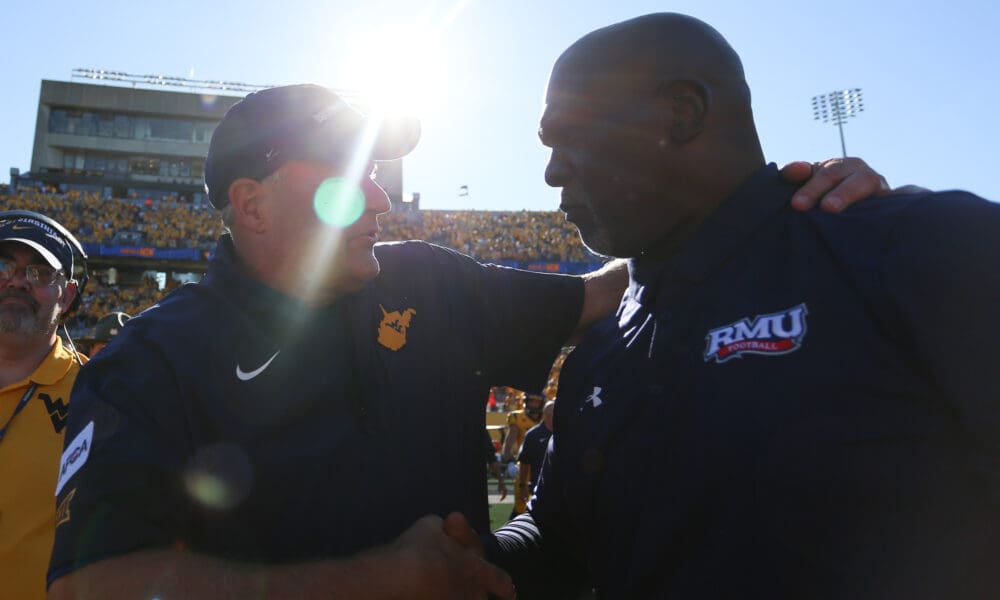 WVU Football HC Rich Rodriguez shakes hands with RMU head coach after season opening win
