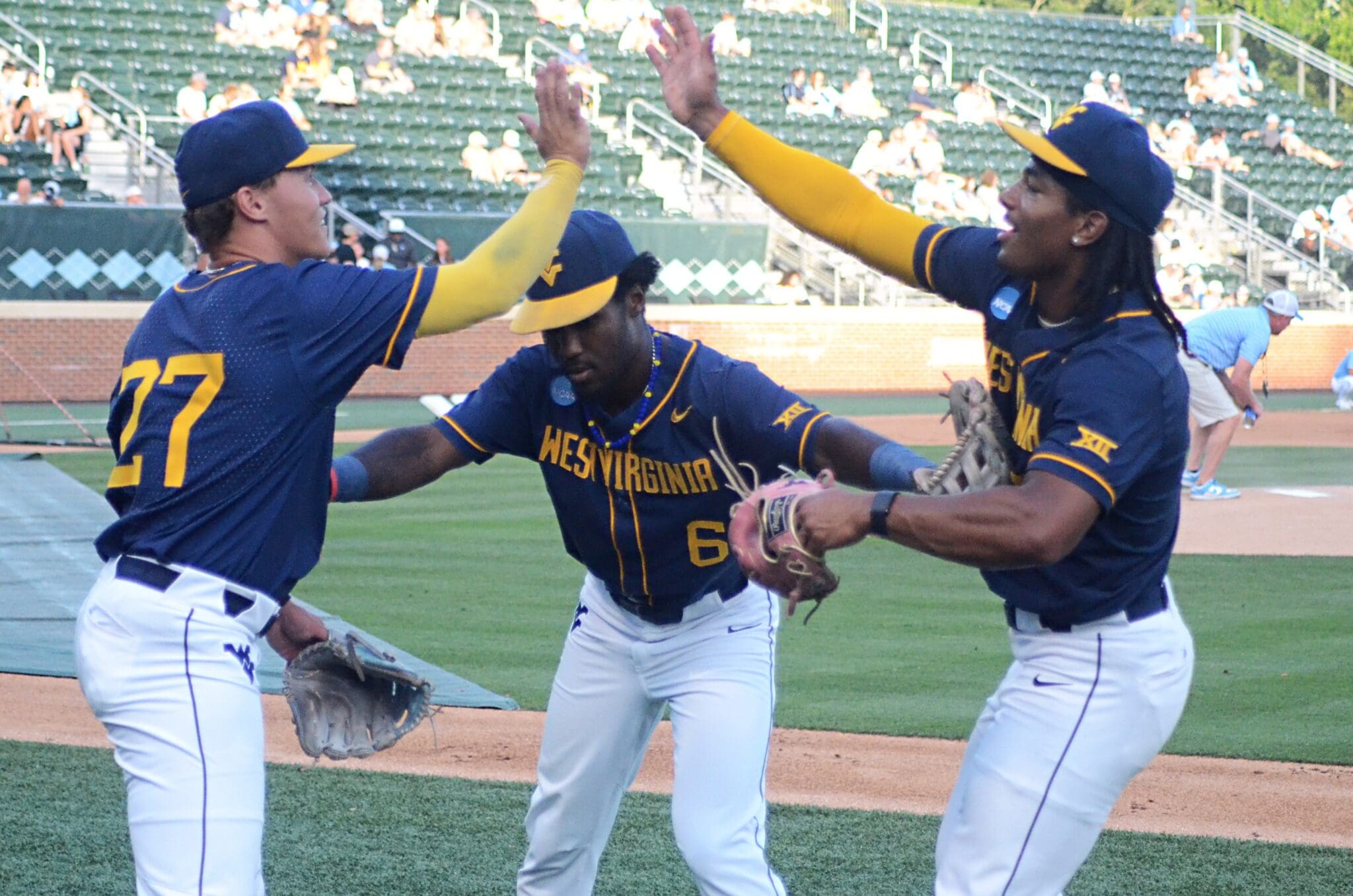 WVU Baseball players goof around as the Mountaineers played against North Carolina on June 8, 2024, in the Super Regionals of the NCAA Tournament at Boshamer Stadium in Chapel Hill, N.C. (Mitchell Northam / WV Sports Now)