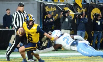 WVU Football quarterback Garrett Greene scrambles against UNC in the Duke's Mayo Bowl at Bank of America Stadium in Charlotte, N.C. on Dec. 27, 2023. (Mitchell Northam / WV Sports Now)