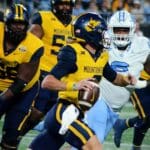WVU quarterback Garrett Greene scrambles against UNC in the Duke's Mayo Bowl at Bank of America Stadium in Charlotte, N.C. on Dec. 27, 2023. (Mitchell Northam / WV Sports Now)