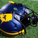 A WVU football helmet rests on the sideline at the Duke's Mayo Bowl on Dec. 27, 2023 at Bank of America Stadium in Charlotte, N.C. (Mitchell Northam / WV Sports Now)