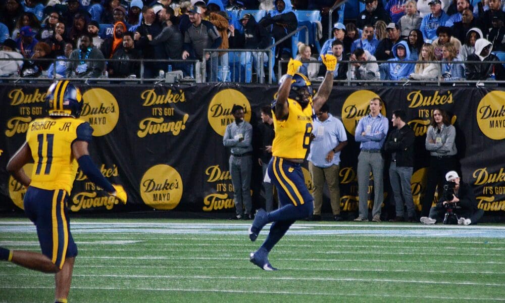 WVU Football linebacker Tyrin Bradley celebrates his third quarter interception against UNC at the Duke's Mayo Bowl on Dec. 27, 2023, at Bank of America Stadium in Charlotte, N.C. (Mitchell Northam / WV Sports Now)