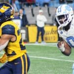 WVU running back Jahiem White rushes against UNC in the Duke's Mayo Bowl at Bank of America Stadium in Charlotte, N.C. on Dec. 27, 2023. (Mitchell Northam / WV Sports Now)