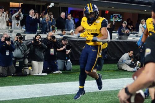 WVU running back Jahiem White celebrates his touchdown against UNC in the Duke's Mayo Bowl at Bank of America Stadium in Charlotte, N.C. on Dec. 27, 2023. (Mitchell Northam / WV Sports Now)