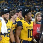 Jared Bartlett and WVU players celebrate beating UNC in the Duke's Mayo Bowl at Bank of America Stadium in Charlotte, N.C. on Dec. 27, 2023. (Mitchell Northam / WV Sports Now)