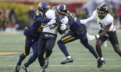 WVU Football safety Anthony Wilson tackles RJ Harvey