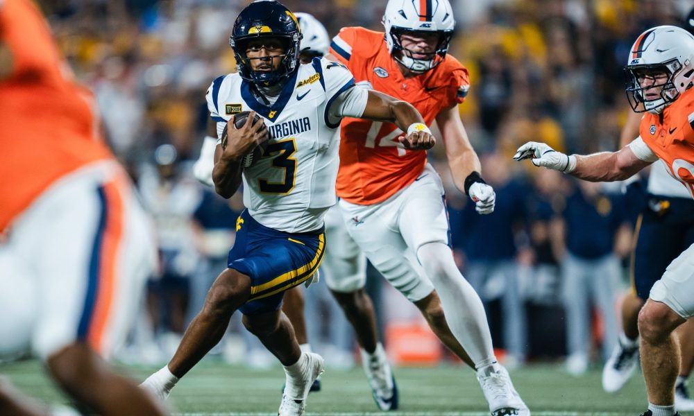 WVU Football QB Michael Hawkins scrmabling against Virginia