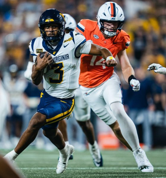 WVU Football QB Michael Hawkins scrmabling against Virginia