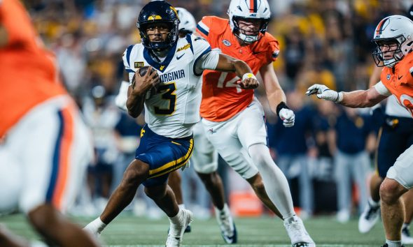 WVU Football QB Michael Hawkins scrmabling against Virginia