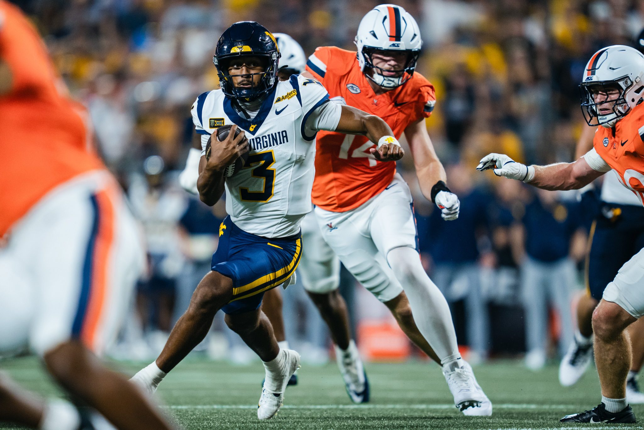 WVU Football QB Michael Hawkins scrmabling against Virginia