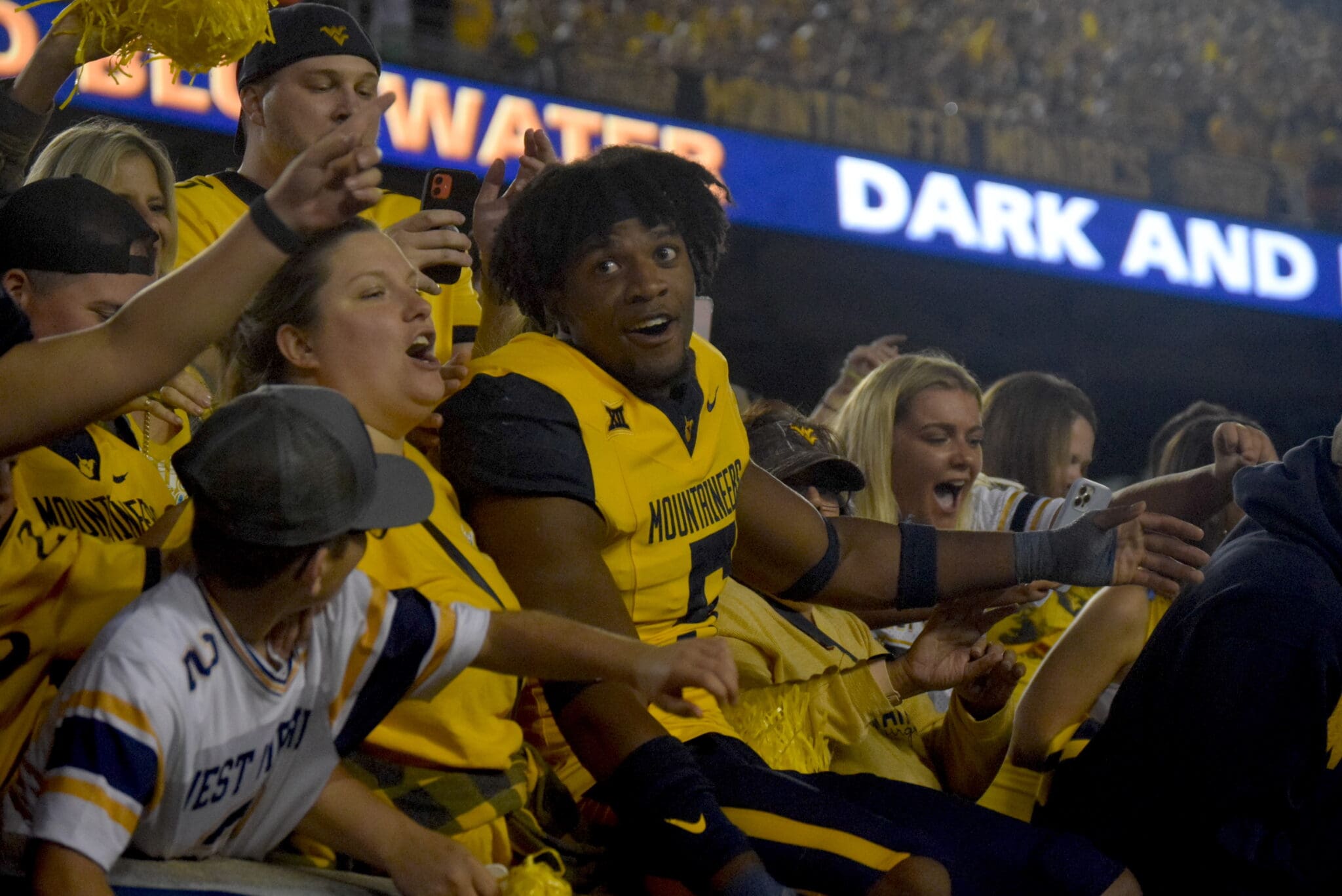 WVU Football Lance Dixon celebrates with fans
