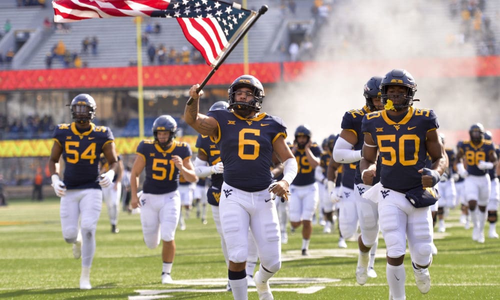 WVU Football team with flag